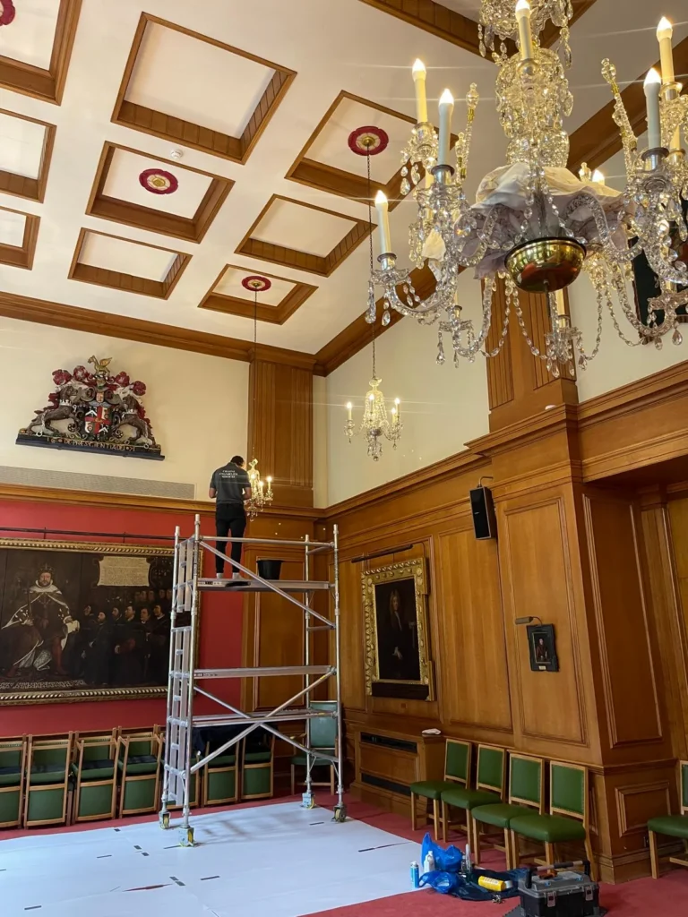 Zac working at height on a chandelier