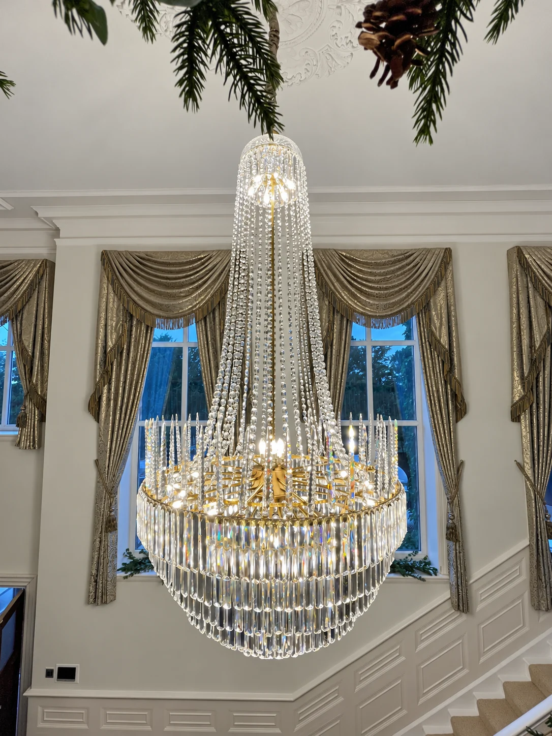 Long crystal chandelier in a double-height room